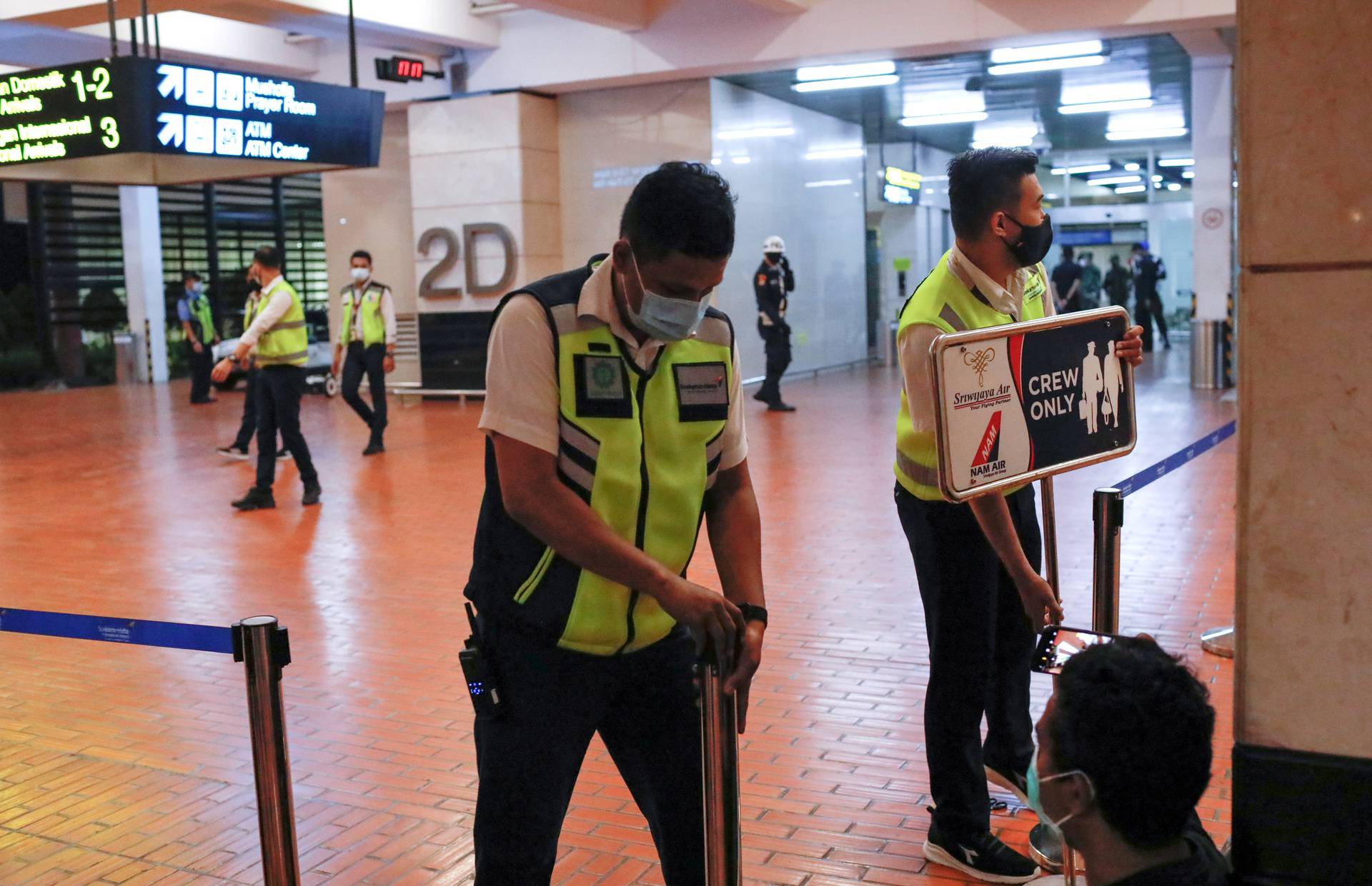 Airport officials install barriers at Soekarno-Hatta International Airport in Tangerang