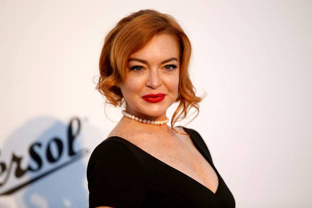FILE PHOTO: Lindsay Lohan poses upon arrival at the 70th Cannes Film Festival The amfAR