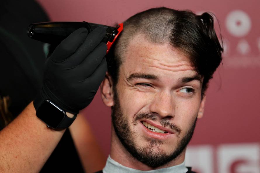 A fan gets his head shaved for a free preview of Yorgos Lanthimos’s new film 'Bugonia', in California