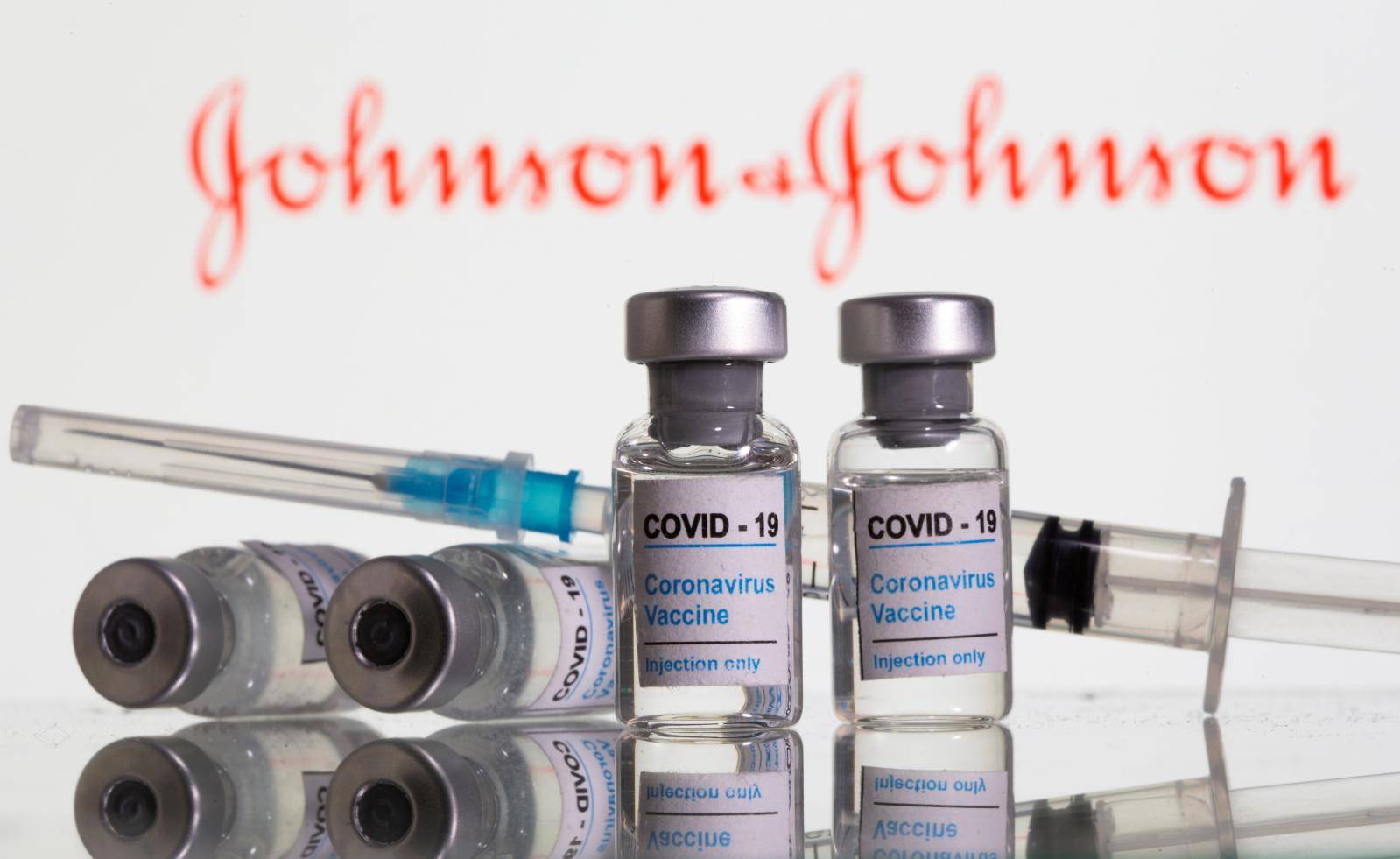FILE PHOTO: FILE PHOTO: Vials labelled "COVID-19 Coronavirus Vaccine" and sryinge are seen in front of displayed J&J logo in this illustration