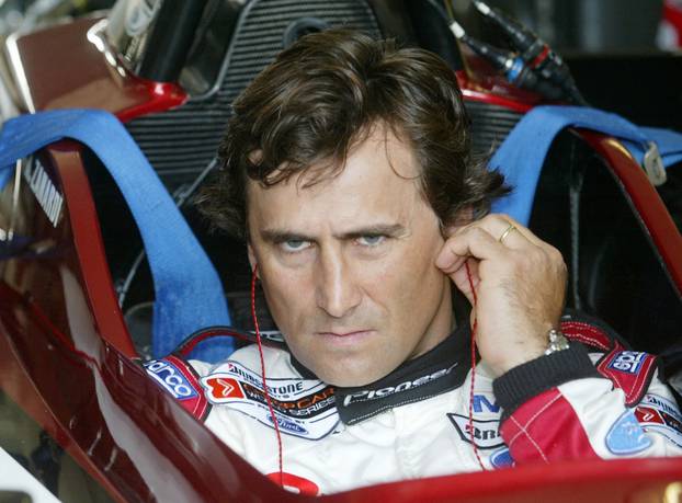 FILE PHOTO: ITALIAN DRIVER ALEX ZANARDI USES HIS EAR STICKS BEFORE HIS RACE IN KLETTWITZ.