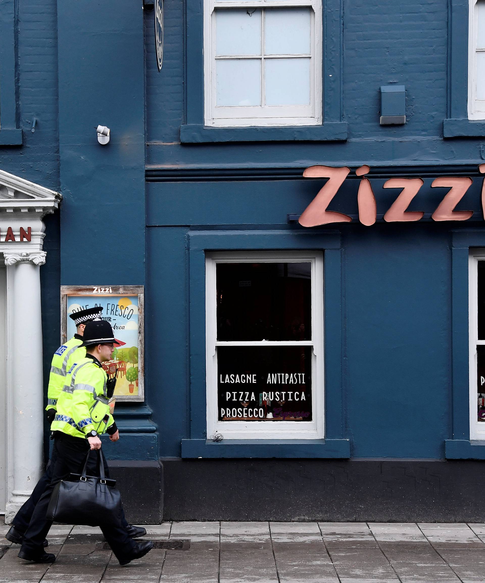 A police officer stands outside a restaurant which was closed after former Russian inteligence officer Sergei Skripal, and a woman were found unconscious on a bench nearby after they had been exposed to an unknown substance, in Salisbury