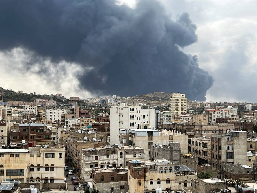 Smoke billows after an Israeli airstrike on Houthi infrastructure, in Sana'a