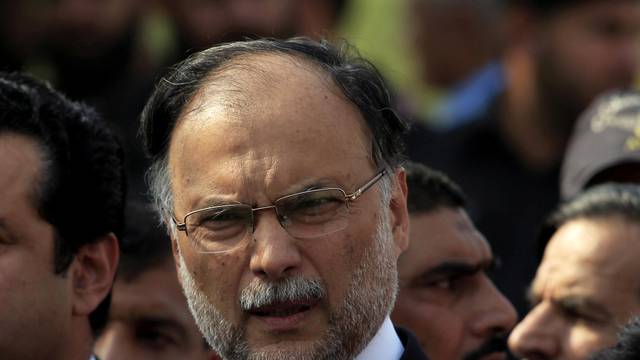 FILE PHOTO: Pakistan's Interior Minister Ahsan Iqbal speaks to media outside the accountability court in Islamabad