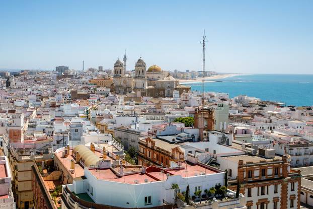 Aerial panoramic view of the old city rooftops and Cathedral de Santa Cruz in the afternoon from tower Tavira in Cadiz, Andalusia, Spain
