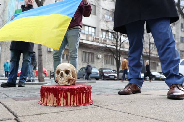 A pro-Ukrainian activists in Serbia delivers a bloody cake and a skull to police guarding Russian embassy in Belgrade