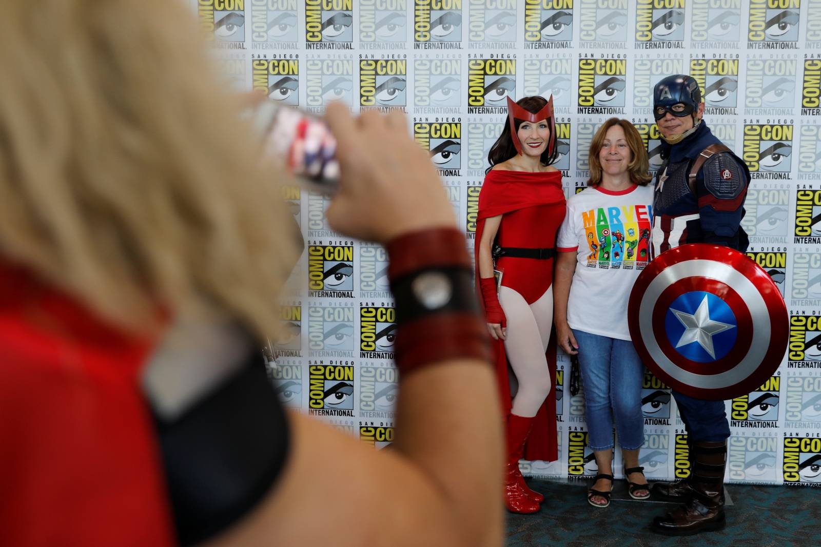 Attendees pose for a picture as they arrive in costumes to enjoy Comic Con International in San Diego