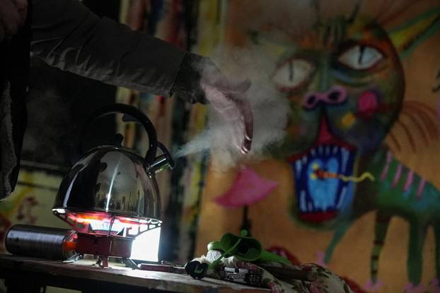 Ukrainian artist works at his studio during a power blackout in Kyiv