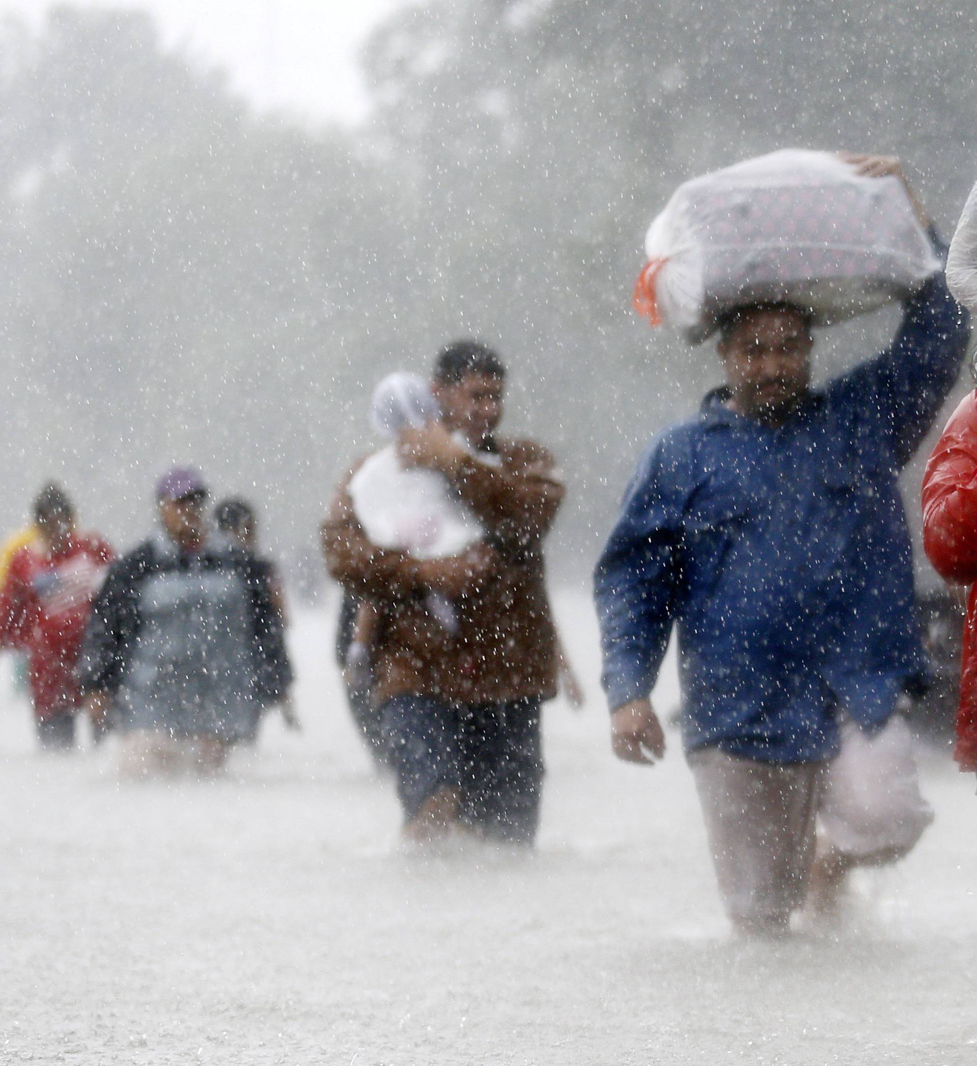 Residents wade through flood waters from Tropical Storm Harvey in Beaumont Place