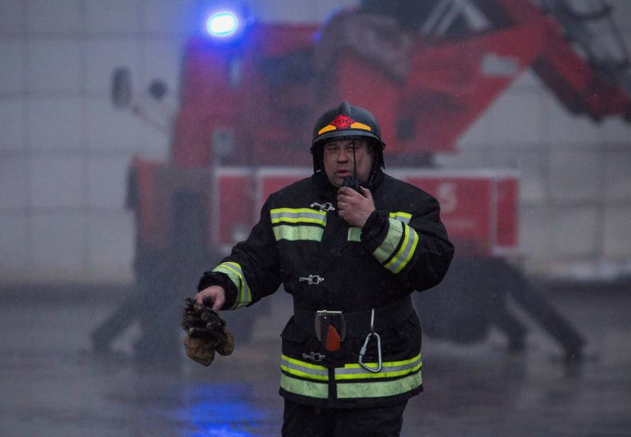 A member of the Emergency Situations Ministry works at the scene of a fire in a shopping mall in Kemerovo
