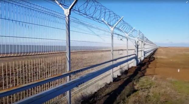 A still image taken from a video footage shows a 60-kilometre fence separating Crimea peninsula from continental Ukraine in Armyansk region