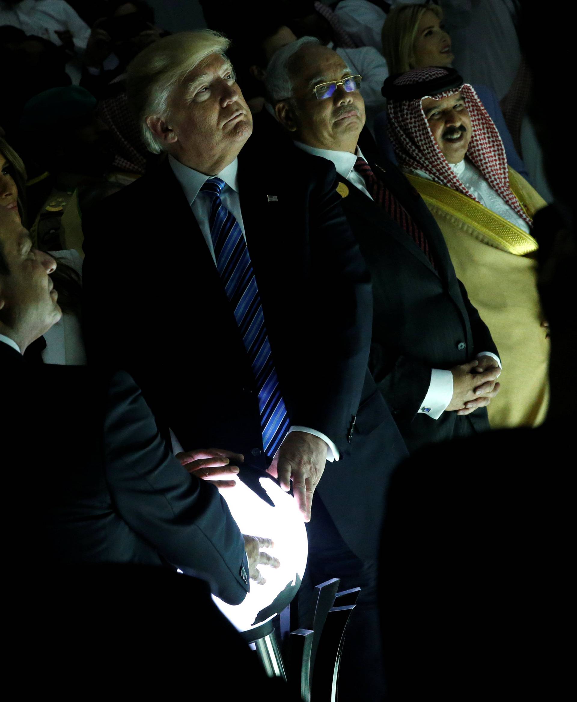 Trump and other leaders react to a wall of computer screens coming online as they tour the Global Center for Combatting Extremist Ideology in Riyadh