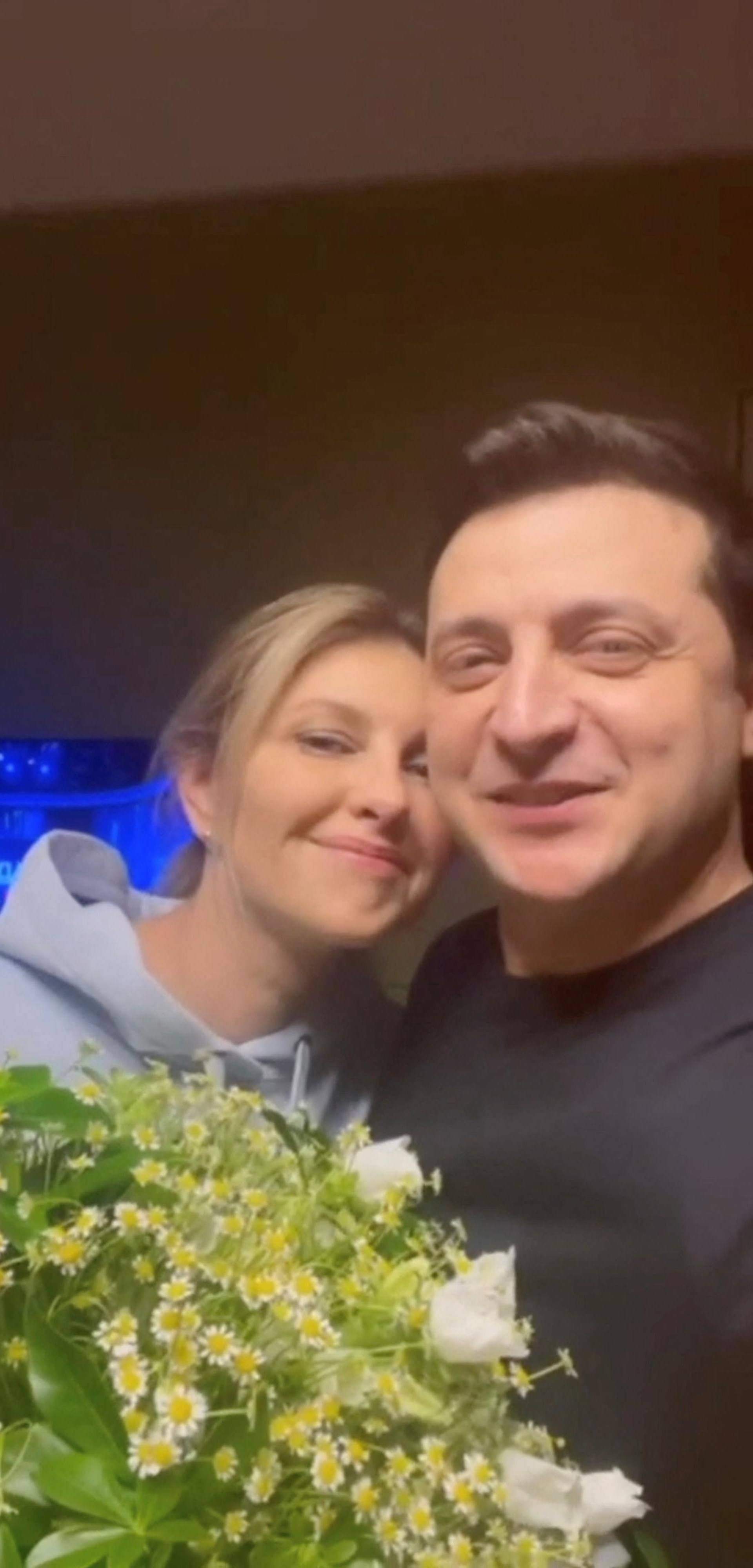 Ukraine's President Volodymyr Zelenskiy speaks while embracing his wife Olena Zelenska on Valentine's Day as they record a message in Kyiv