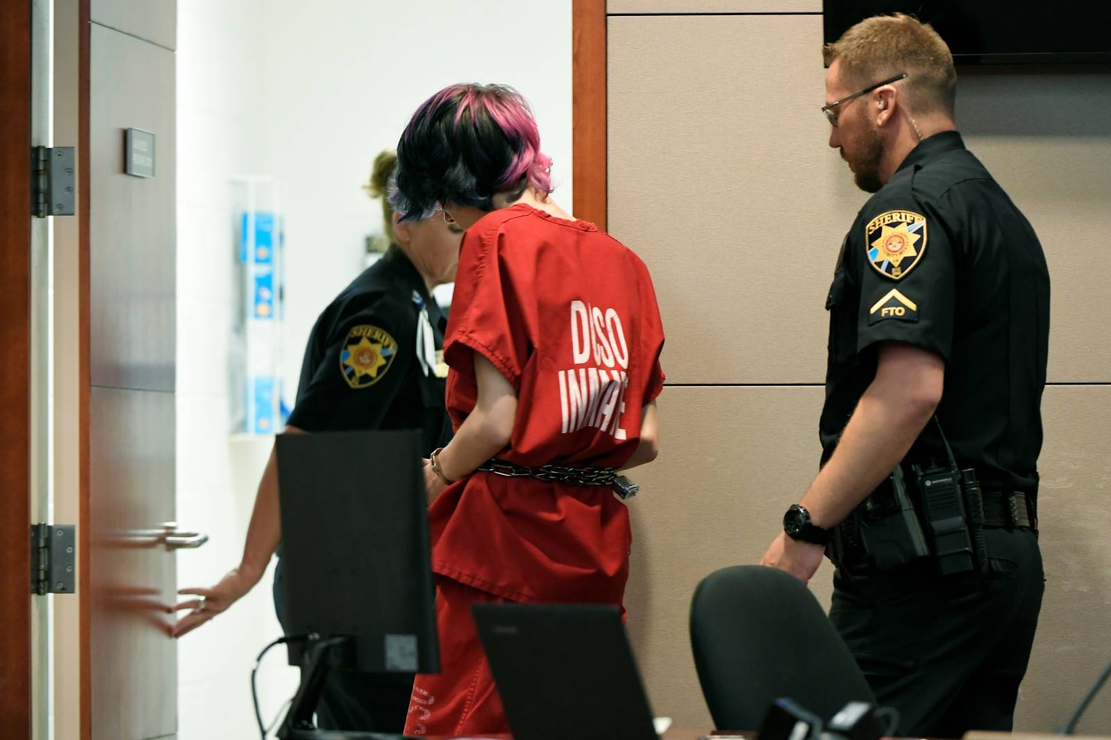 Devon Erickson, 18, accused of taking part in a deadly school shooting, is escorted from the Douglas County Courthouse, in Castle Rock, Colorado