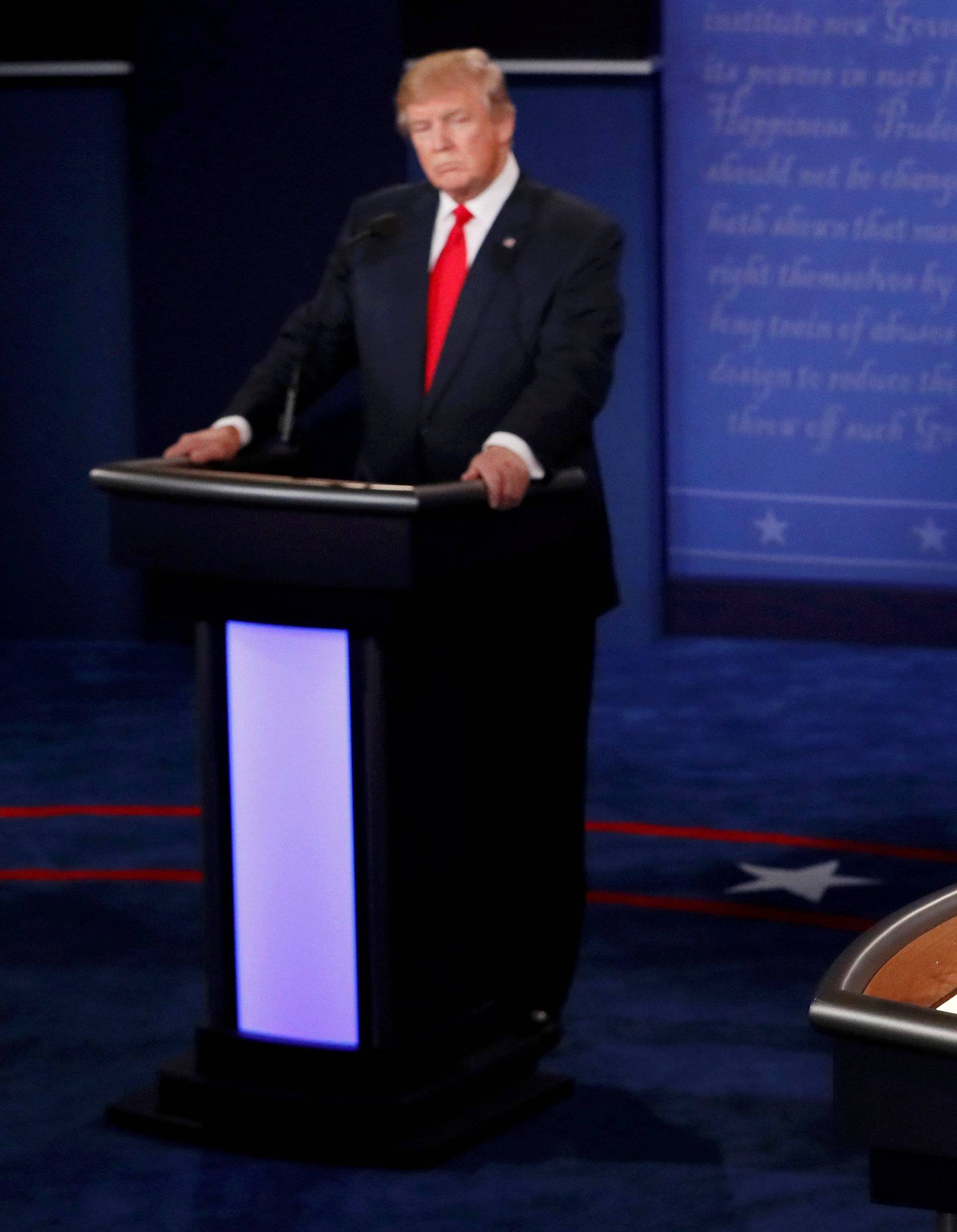 Trump listens as Clinton speaks during their third and final 2016 presidential campaign debate at UNLV in Las Vegas