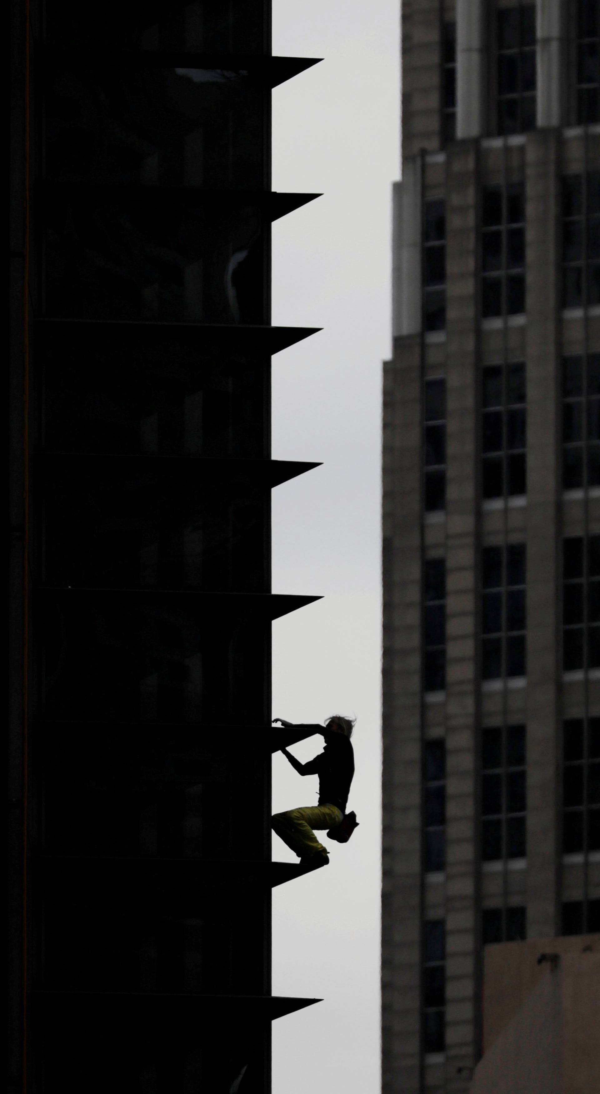 French climber Robert descends the 47-storey GT International Tower in Makati City