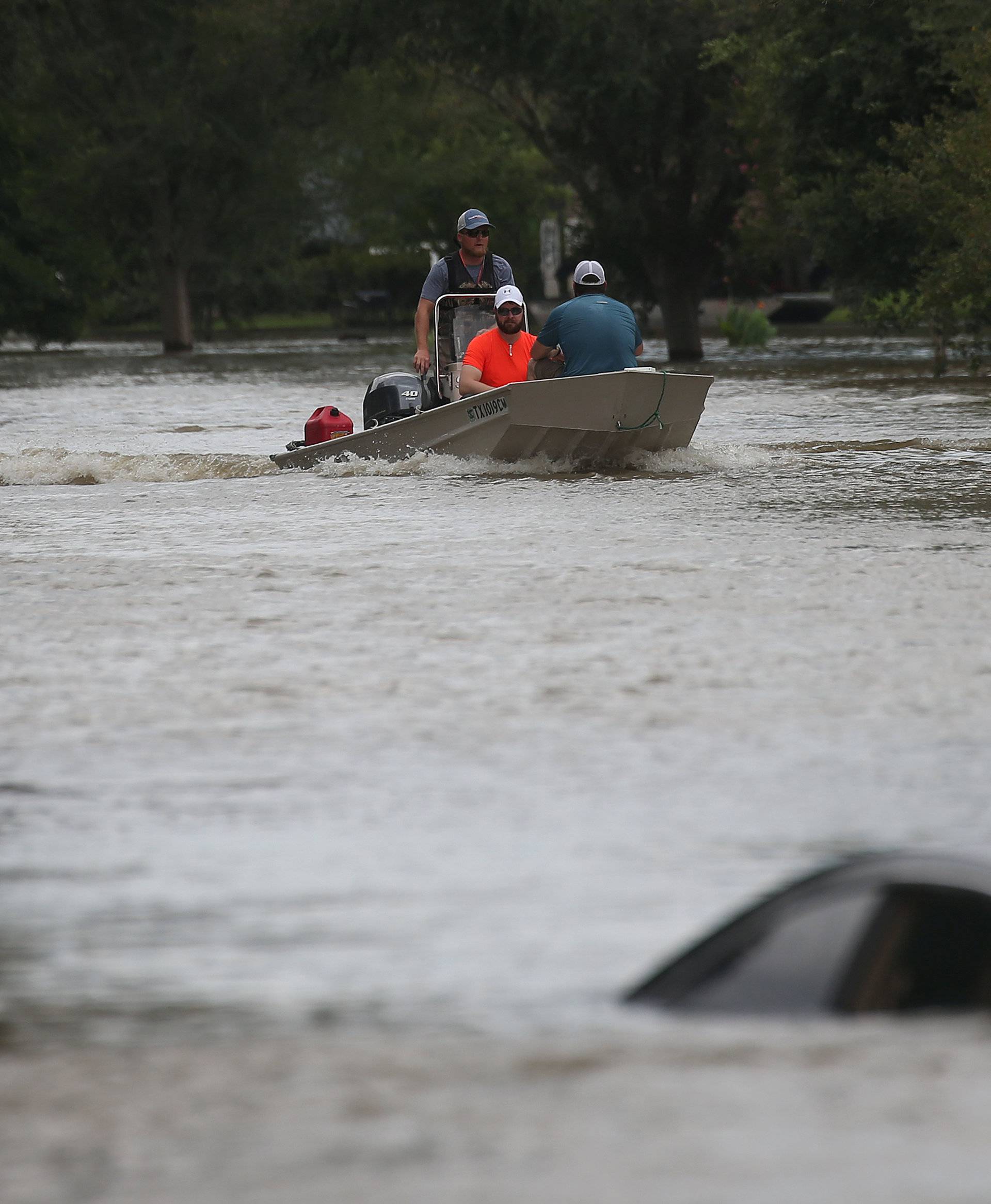 A rescue boat evacuates people from the rising waters of Buffalo Bayou following Hurricane Harvey in a neighborhood west of Houston