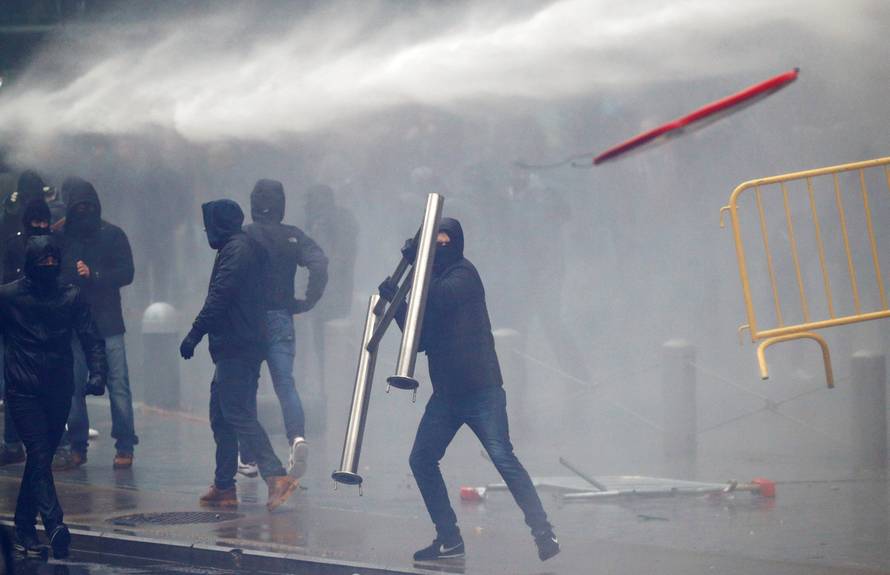 Far-right supporter throws a barricade during a protest against Marrakesh Migration Pact in Brussels