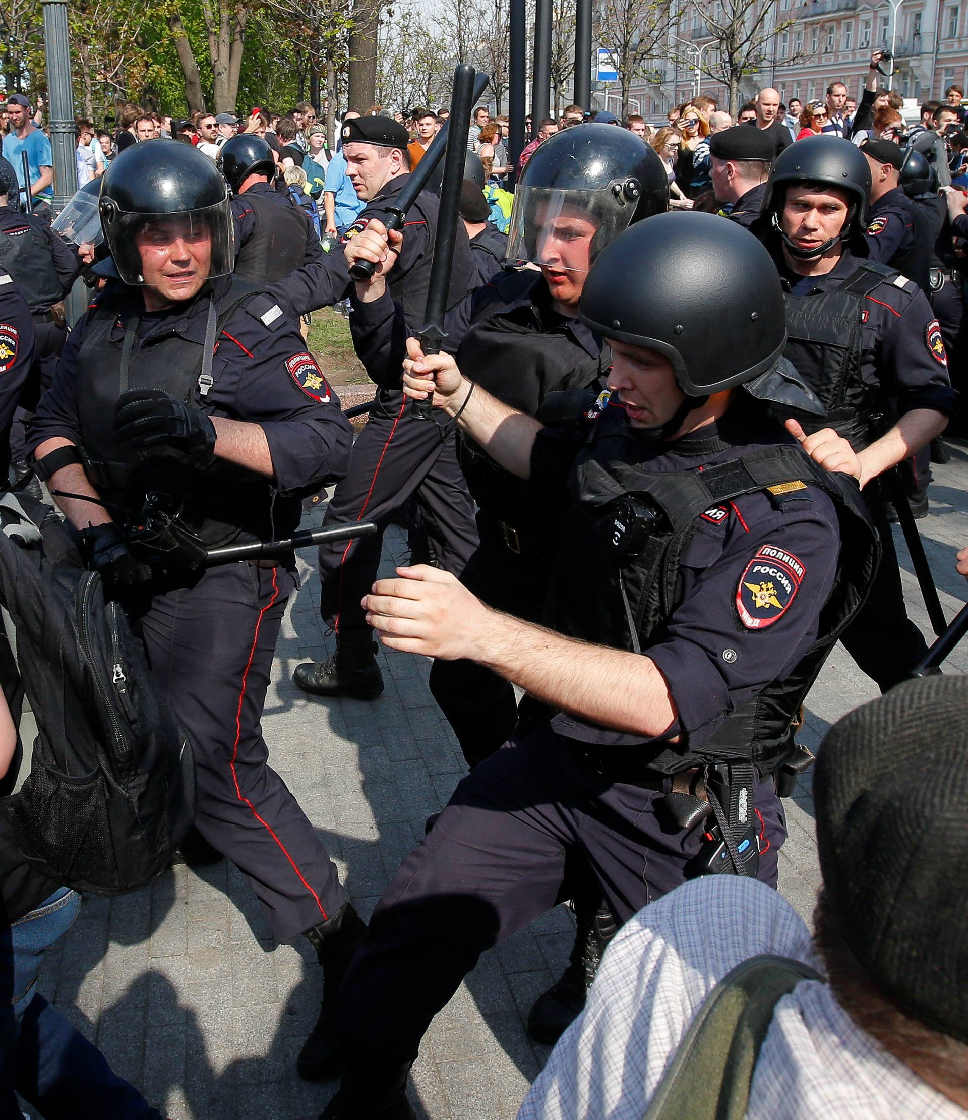 Policemen chase opposition supporters during a protest ahead of President Vladimir Putin's inauguration ceremony, Moscow