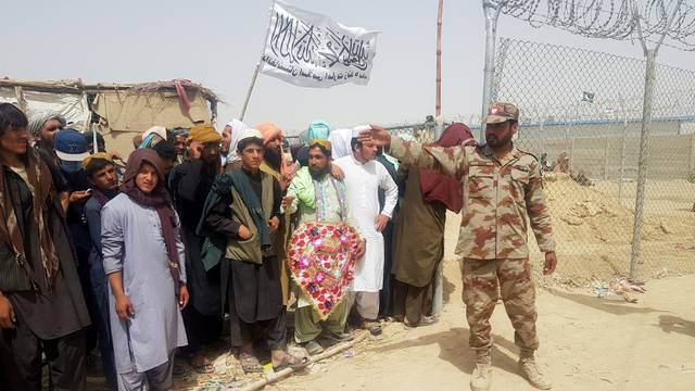 People gather to welcome a man who was released from prison in Afghanistan, in Chaman