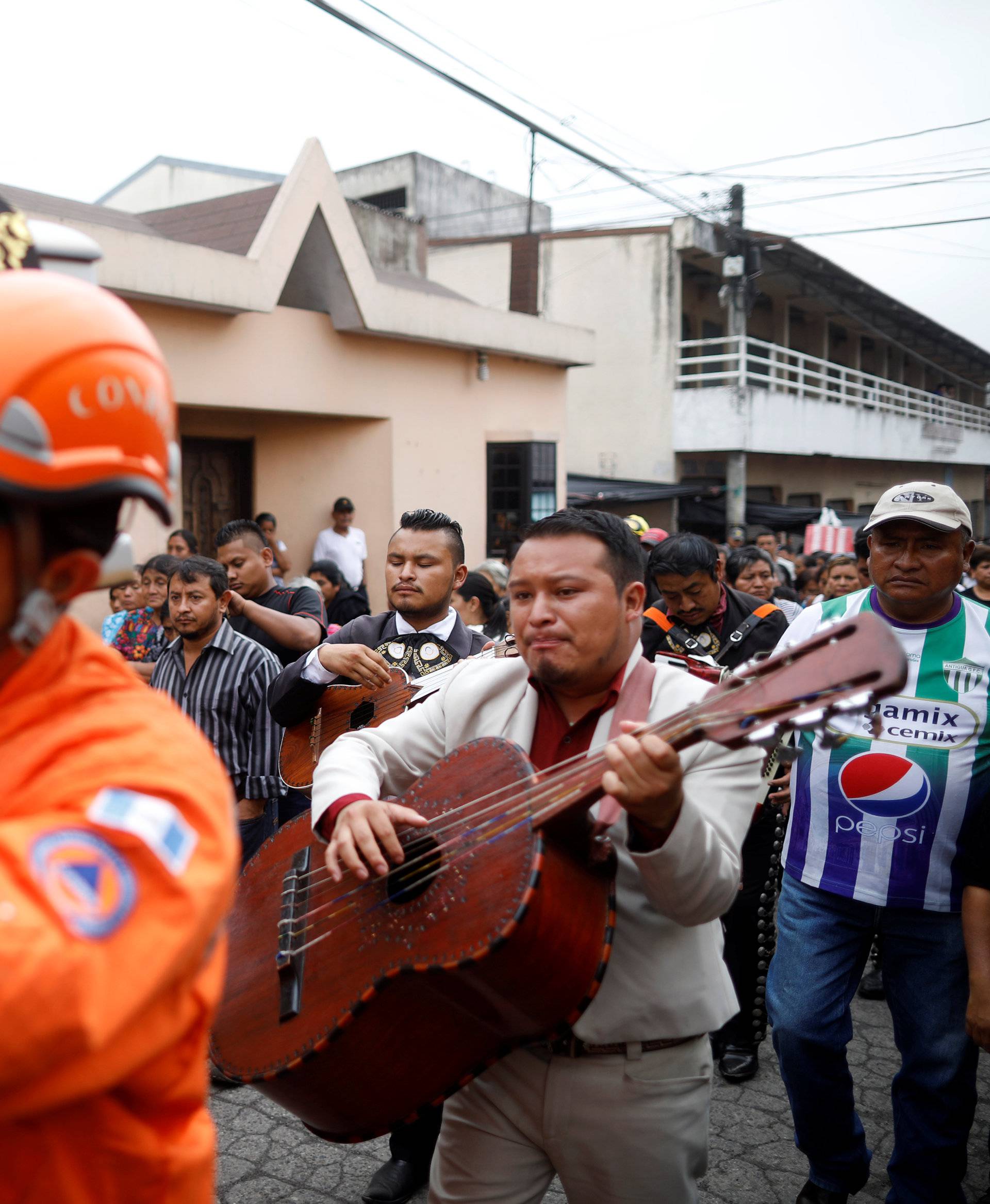 Musicians perform during the funeral of Juan Fernando Galindo, member of the National Coordinator for Disasters Reduction (CONRED), in Alotenango