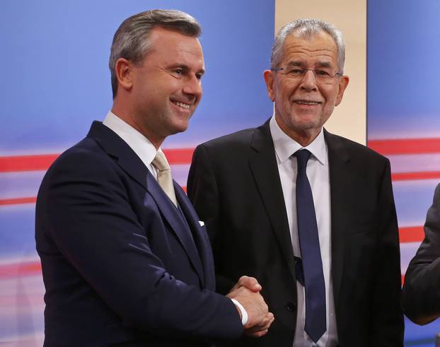 Austrian far-right Freedom Party (FPOe) presidential candidate Hofer and his rival Van der Bellen, who is supported by the Greens, react during a TV show in Vienna