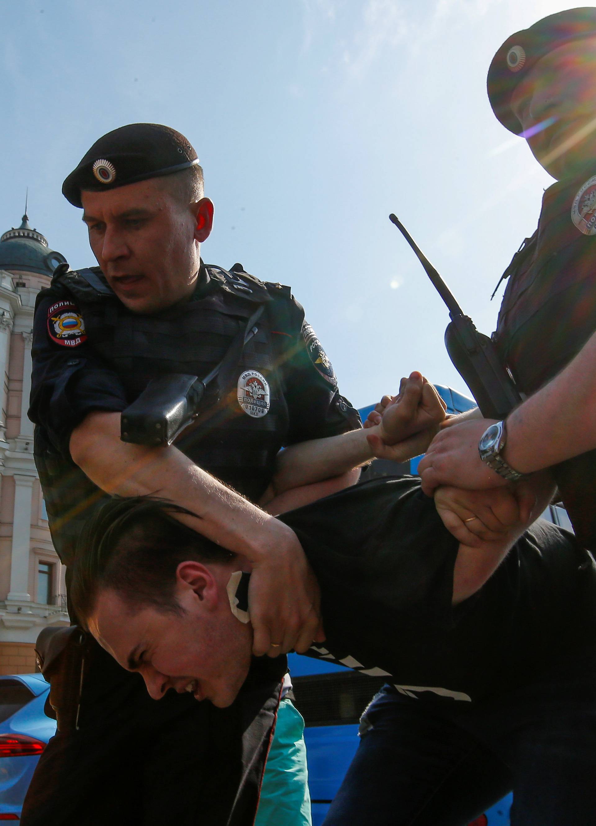 Policemen detain an opposition supporter during a protest ahead of President Vladimir Putin's inauguration ceremony, Moscow