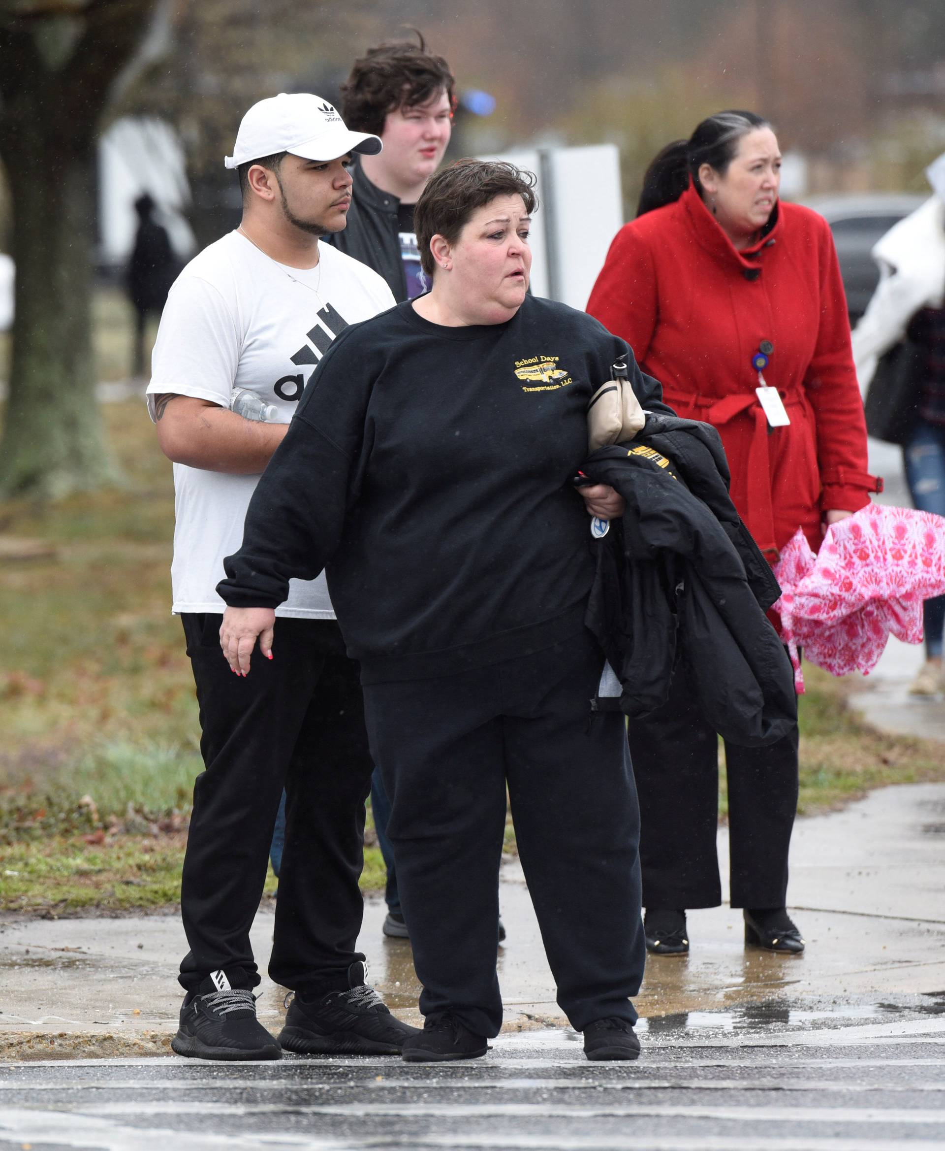 Great Mills High School senior Wayne Waul (2nd L) and his mother Jill Ryan (4th L) leave Leonardtown High School in Leonardtown, Maryland