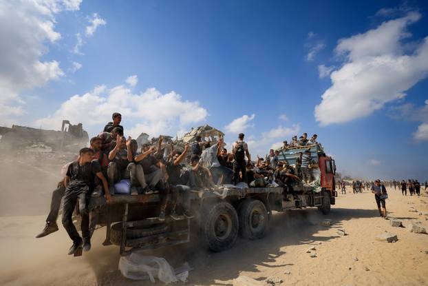 Palestinians gather to receive aid supplies amid a hunger crisis, in Beit Lahia