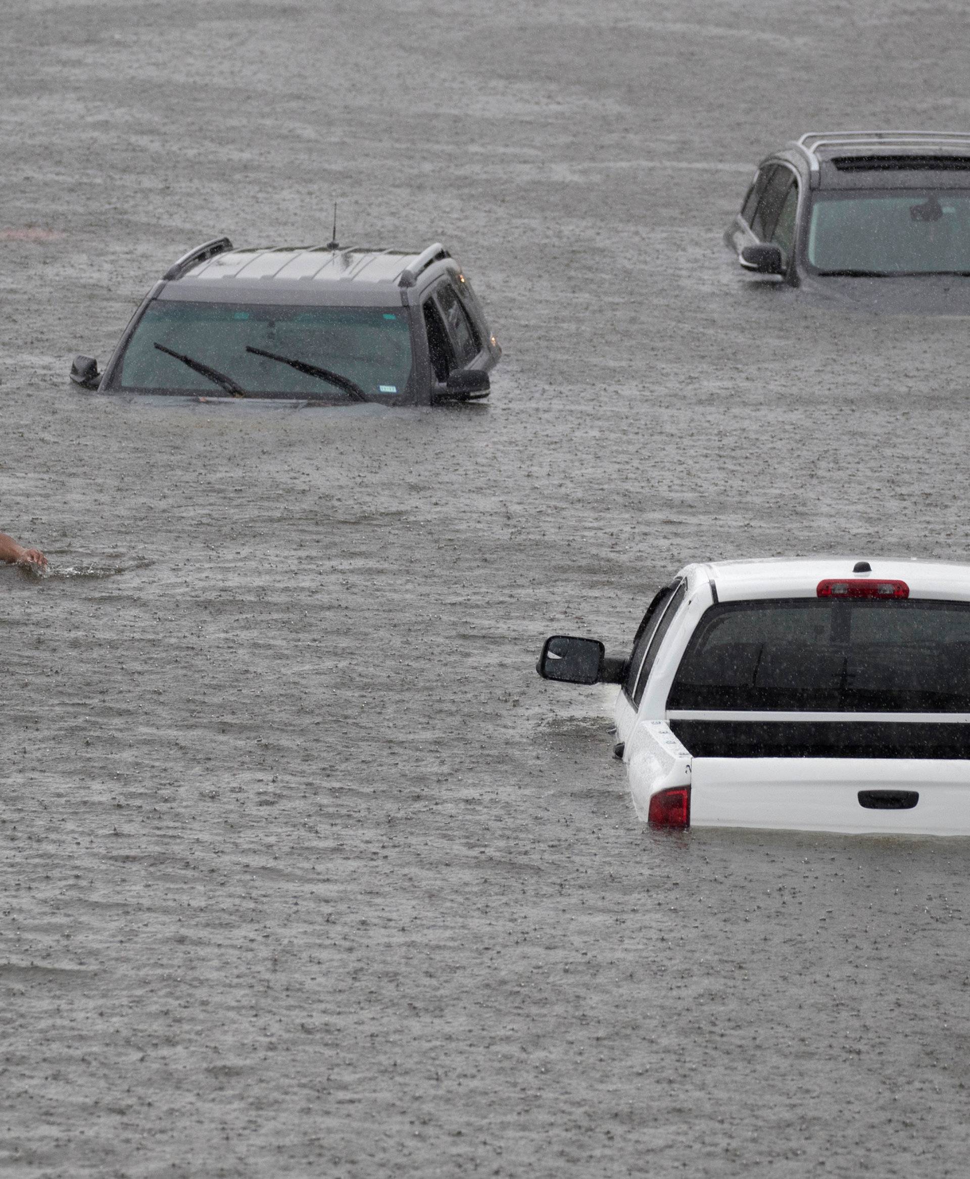 Jesus Rodriguez rescues Gloria Garcia after rain from Hurricane Harvey flooded Pearland, in the outskirts of Houston