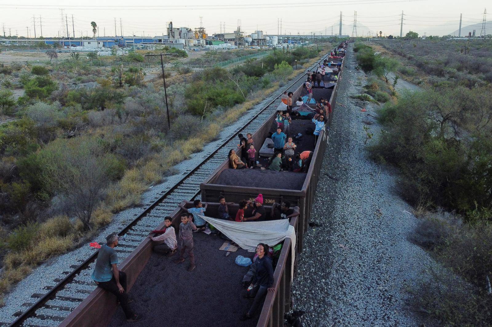 Asylum seekers heading to the U.S. travel on a train, in El Carmen