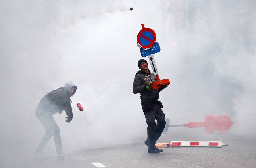 Far-right supporter throws a small container during a protest against Marrakesh Migration Pact in Brussels
