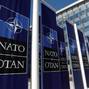 FILE PHOTO: Banners displaying the NATO logo are placed at the entrance of new NATO headquarters during the move to the new building