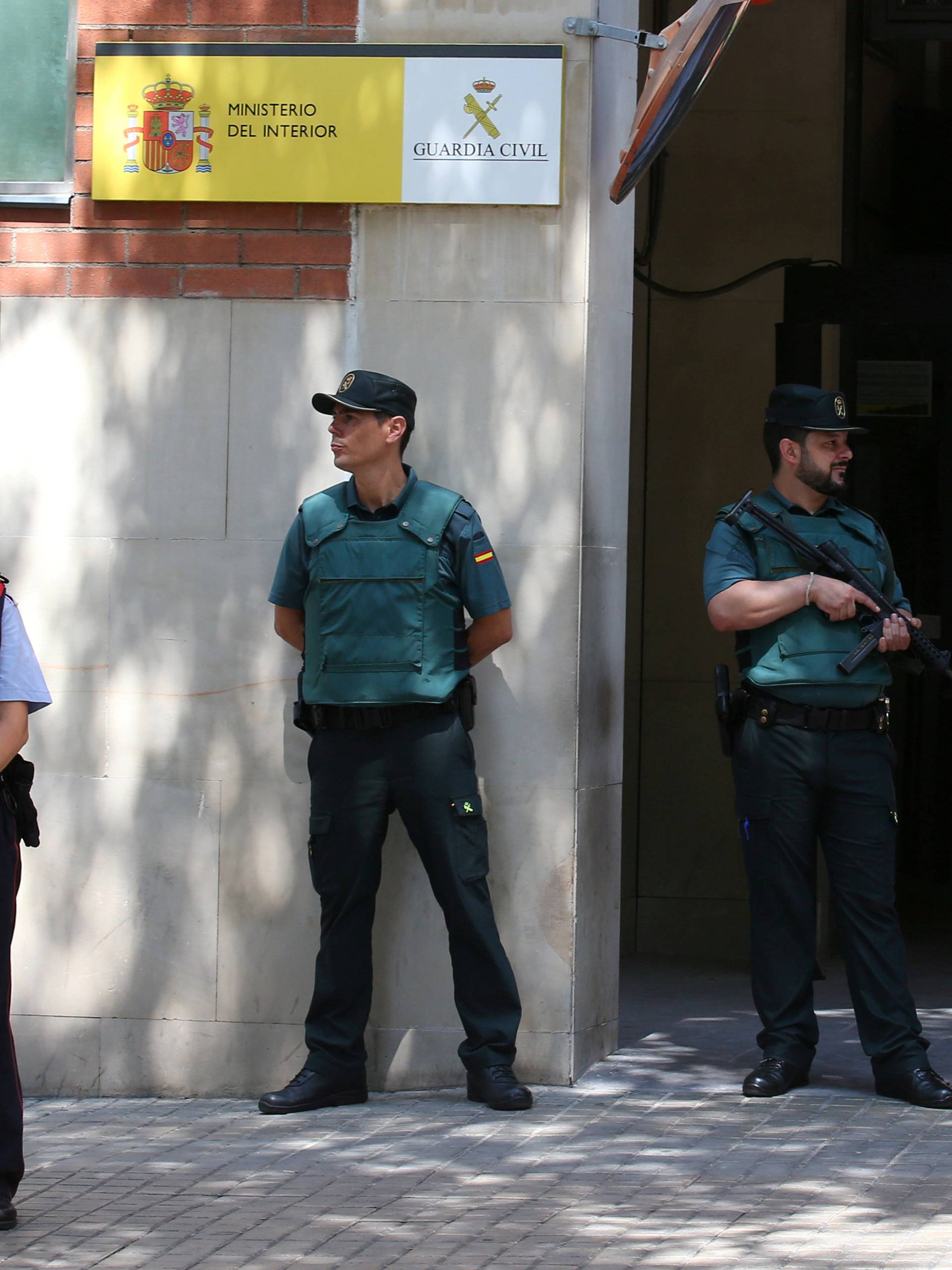 FILE PHOTO: Mossos d'Esquadra officers (Catalan Regional Police) stand guard in front of Civil Guard headquarters during a protest in Barcelona
