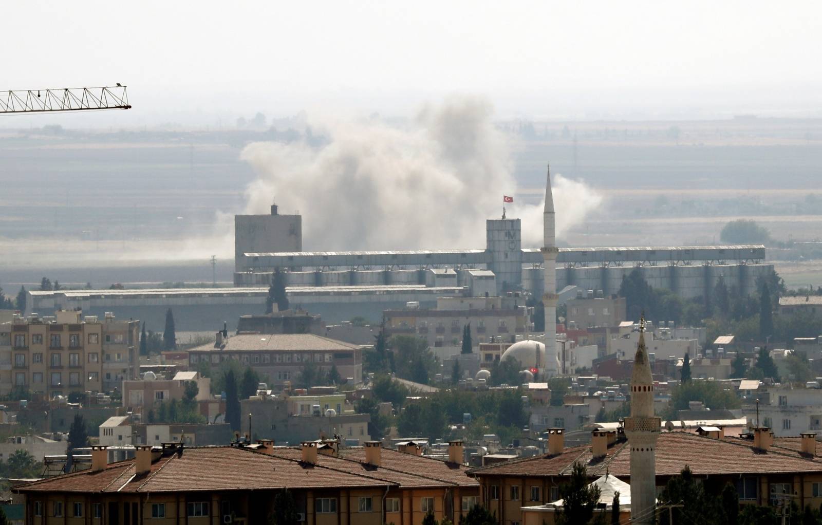 Smoke billows out after Turkish shelling on the Syrian border town of Ras al Ain, as seen from Ceylanpinar