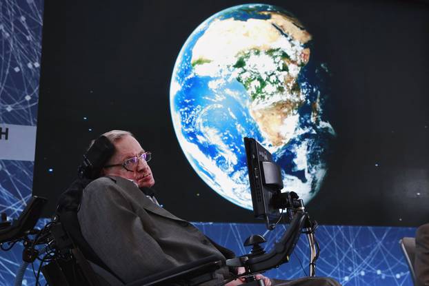 Physicist Stephen Hawking sits on stage during an announcement of the Breakthrough Starshot initiative with investor Yuri Milner in New York 