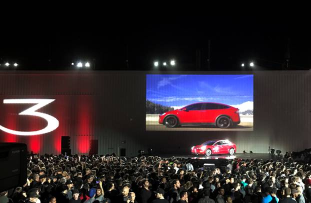 Tesla introduces one of the first Model 3 cars off the Fremont factory