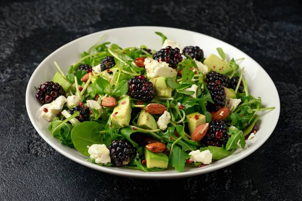 Blackberry salad with greens, almond nuts, feta, avocado and feta cheese