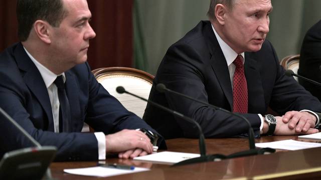 FILE PHOTO: Russian President Putin and Prime Minister Medvedev attend a meeting with members of the government in Moscow