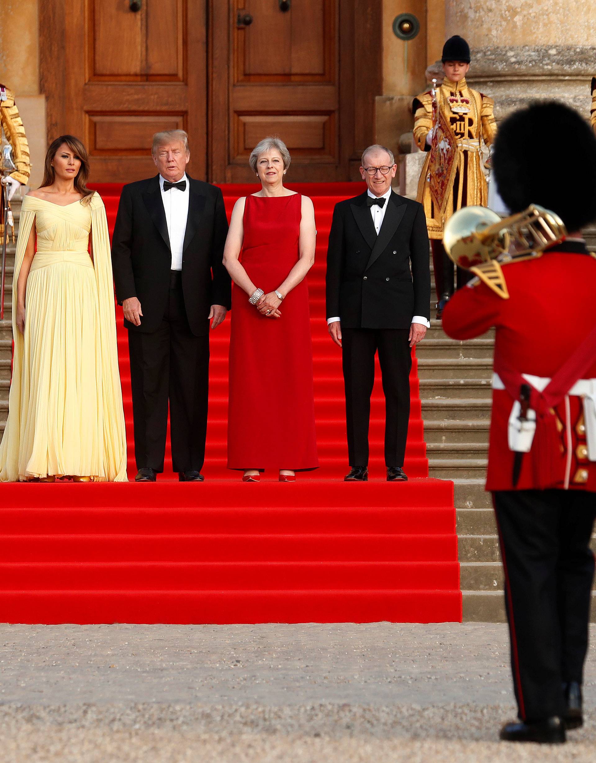 British Prime Minister Theresa May and her husband Philip stand together with U.S. President Donald Trump and First Lady Melania Trump at the entrance to Blenheim Palace near Oxford