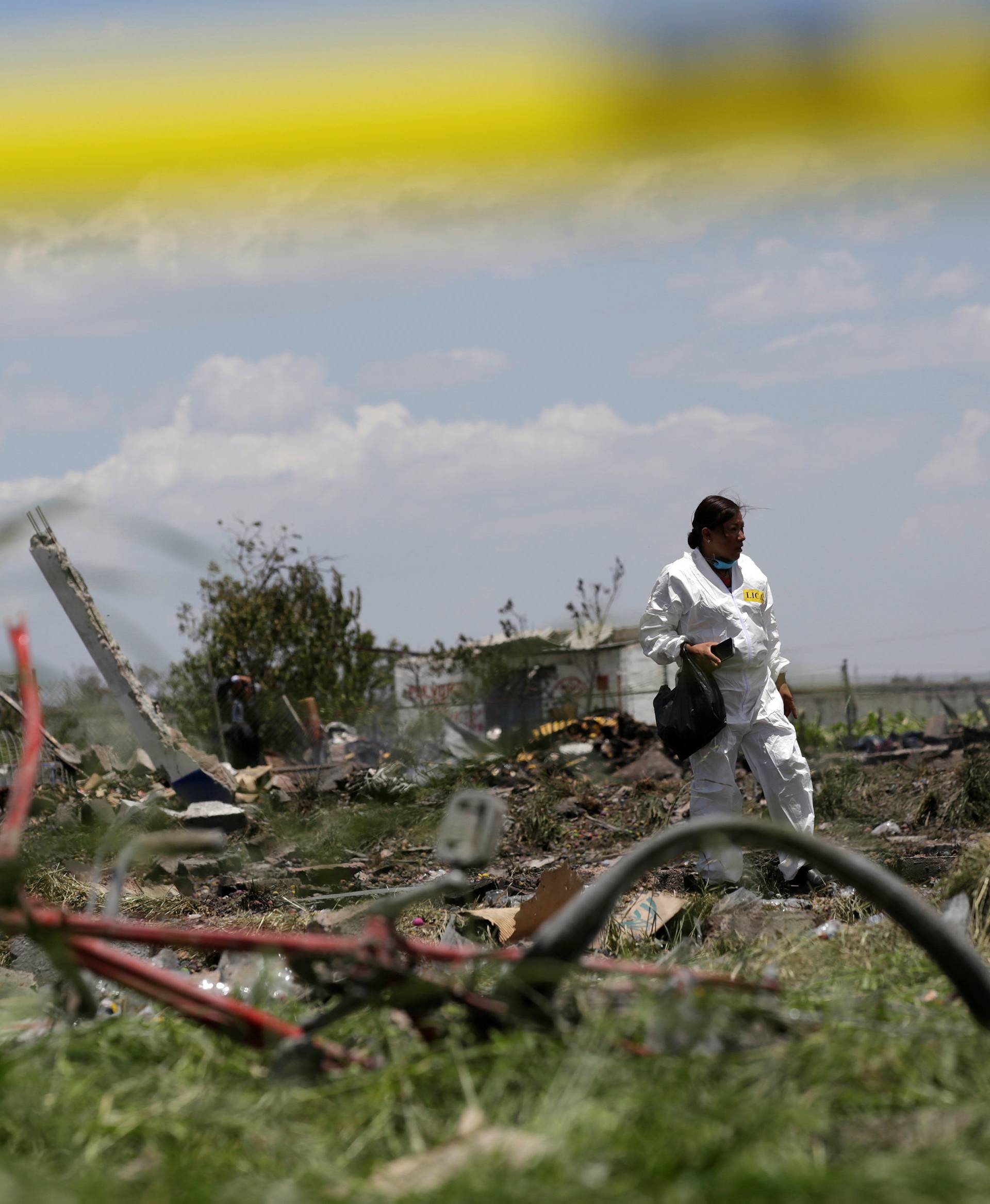 A forensic technician inspects a site damaged due to fireworks explosions in the municipality of Tultepec