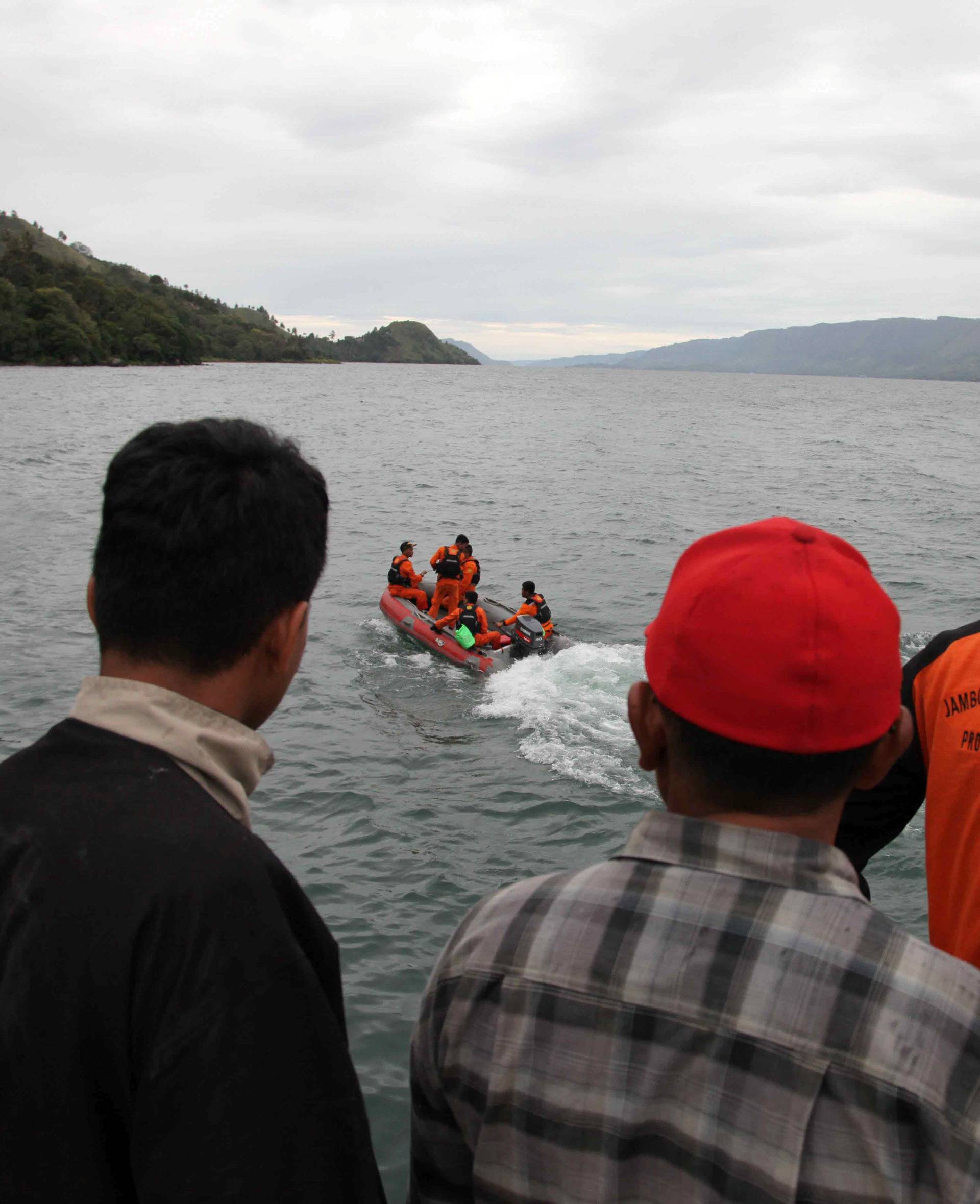 A search and rescue team heads out looking for missing passengers who were on a ferry that sank in Lake Toba