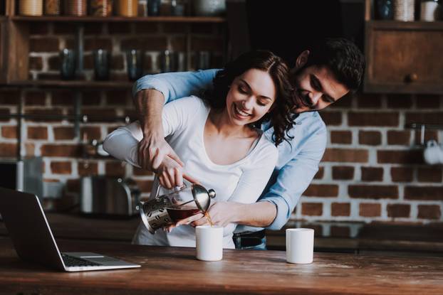 Beautyful Couple in Love Drinking Tea at Home