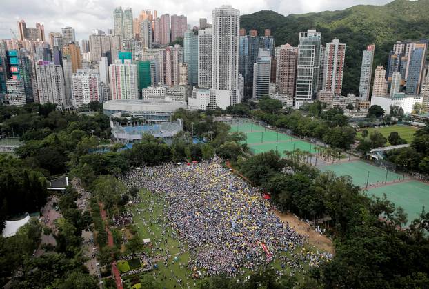 Demonstrators hold yellow umbrellas, the symbol of the Occupy Central movement, during a protest to demand authorities scrap a proposed extradition bill with China, in Hong Kong