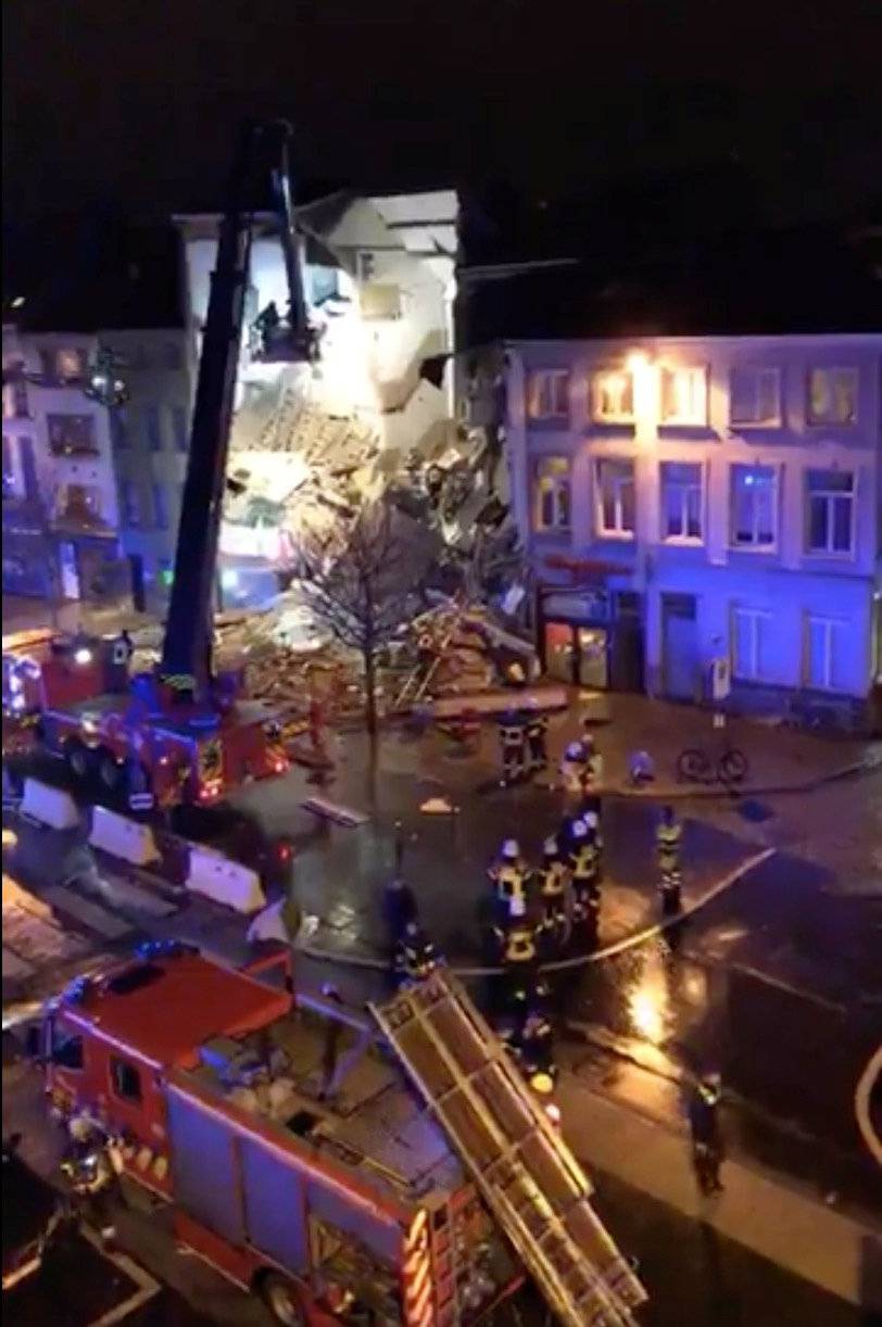 Emergency rescue personnel attend to the scene where a building has collapsed in Antwerp, Belgium