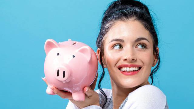 Young woman with a piggy bank