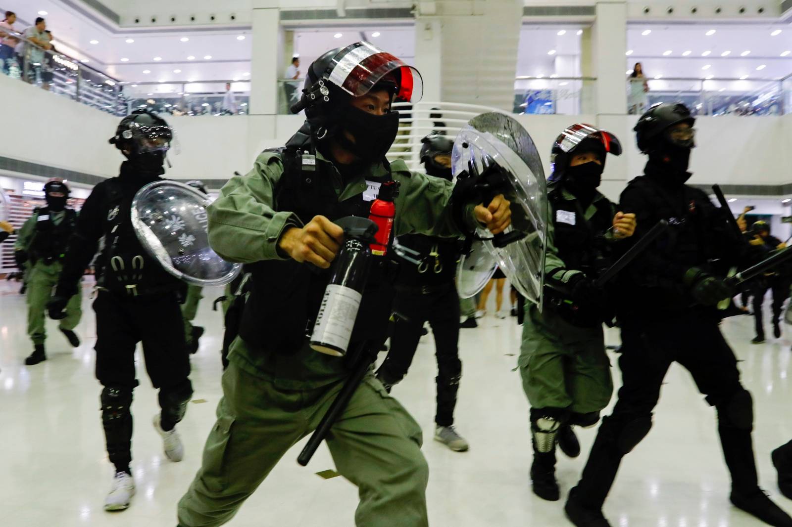 Riot police disperse anti-government protesters at a shopping mall in Tai Po, Hong Kong