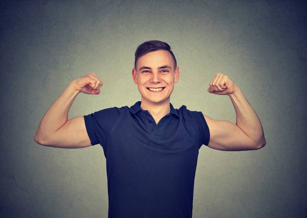 Strong young man showing biceps