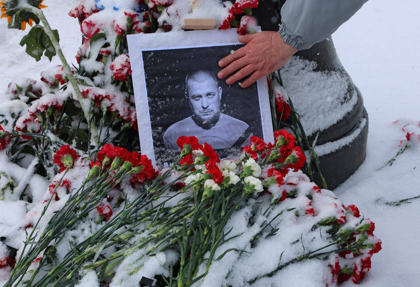 A portrait of Russian military blogger Vladlen Tatarsky, who was killed in the cafe explosion the day before, is placed near the blast site in Saint Petersburg