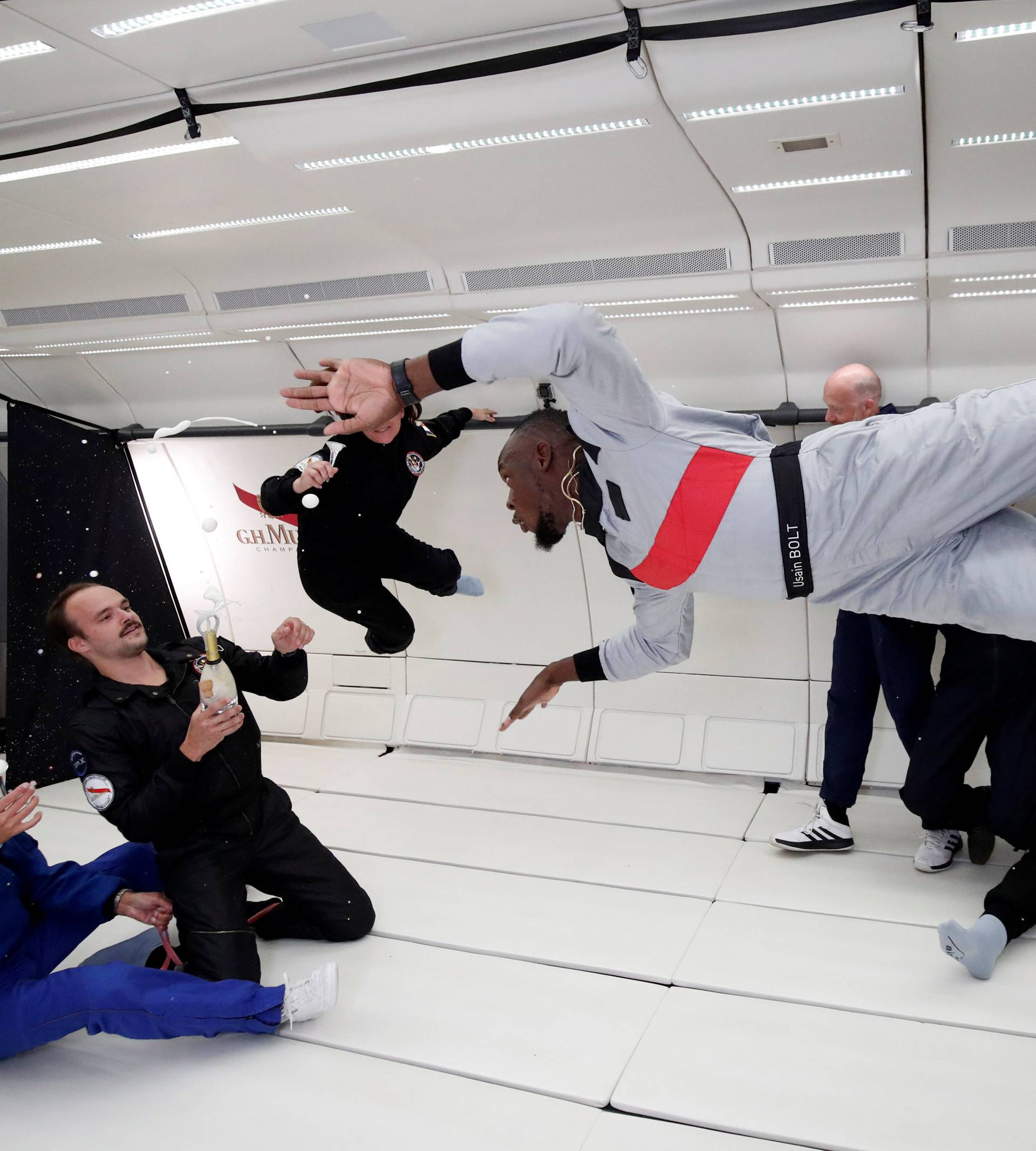 Retired sprinter Usain Bolt, French astronaut Jean-Francois Clervoy and French Interior designer Octave de Gaulle enjoy zero gravity conditions during a flight in a specially modified plane above Reims